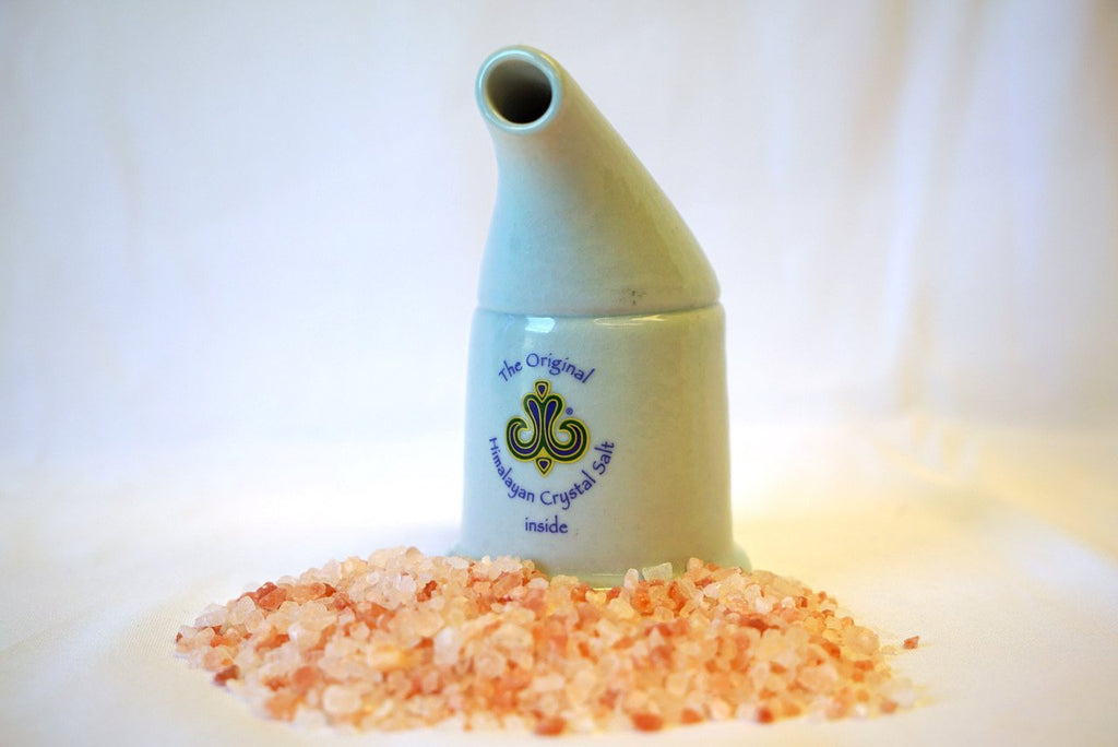 Coarse Salt Refill for Inhaler off-white ceramic inhaler against pile of coarse crystal salt, with white background